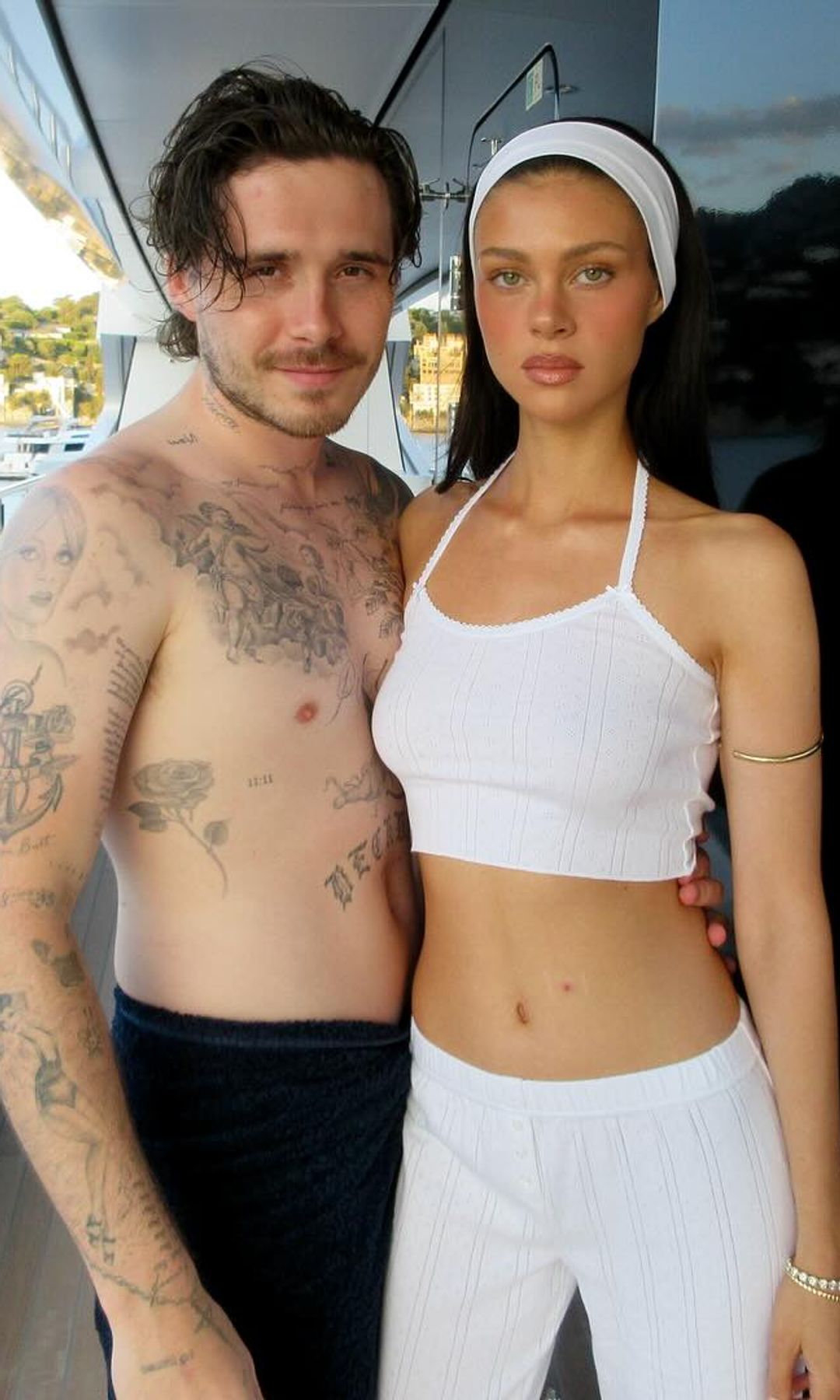 Nicola and Brooklyn Peltz Beckham pose for a photo on a yacht