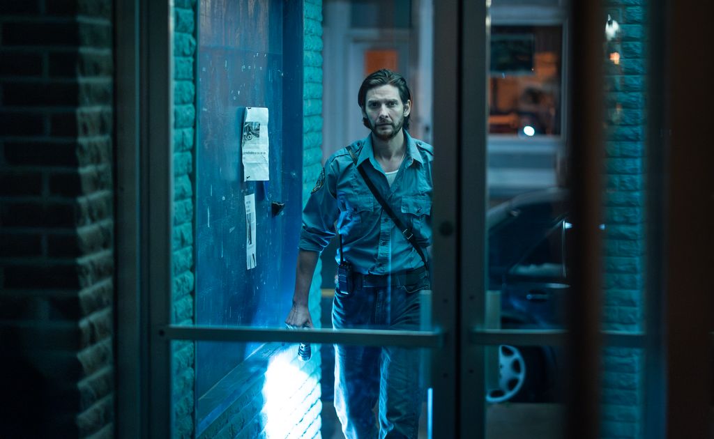 man walking towards glass door