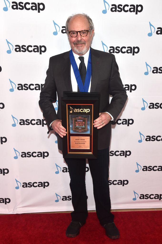 photo of mark snow holding plaque