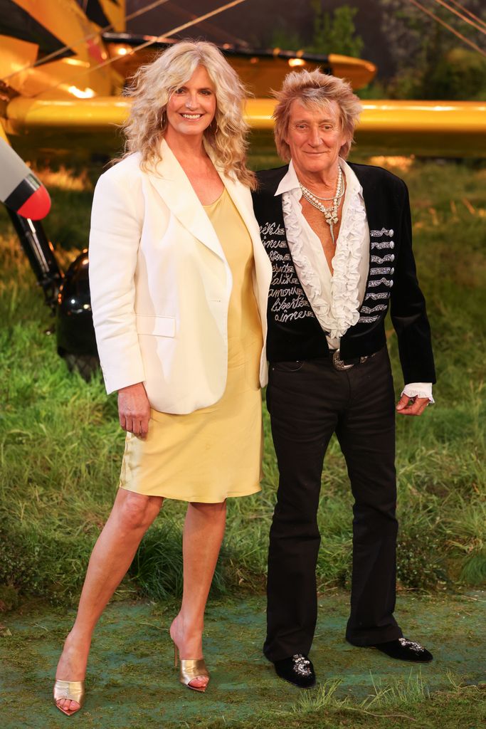 Penny Lancaster in a yellow dress and Rod Stewart in a frilly black suit