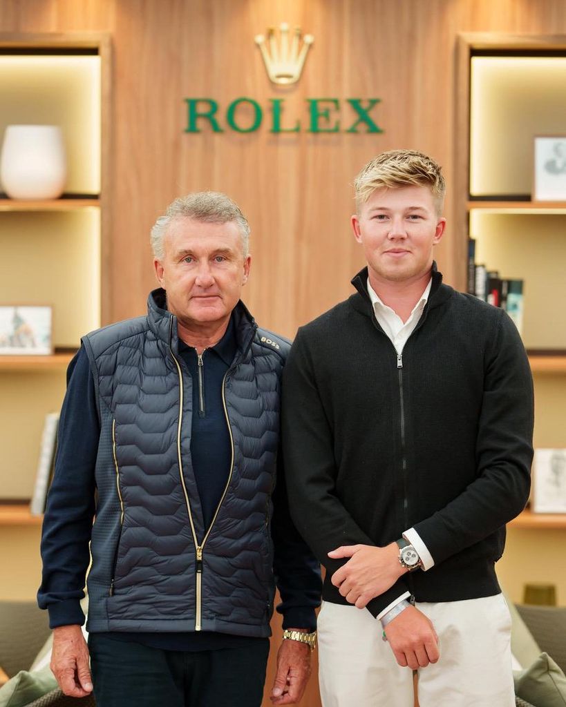 harry charles posing in front or rolex sign