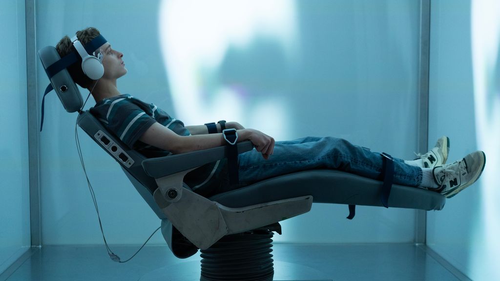 Joe Freeman in character in The Institute lying in a chair