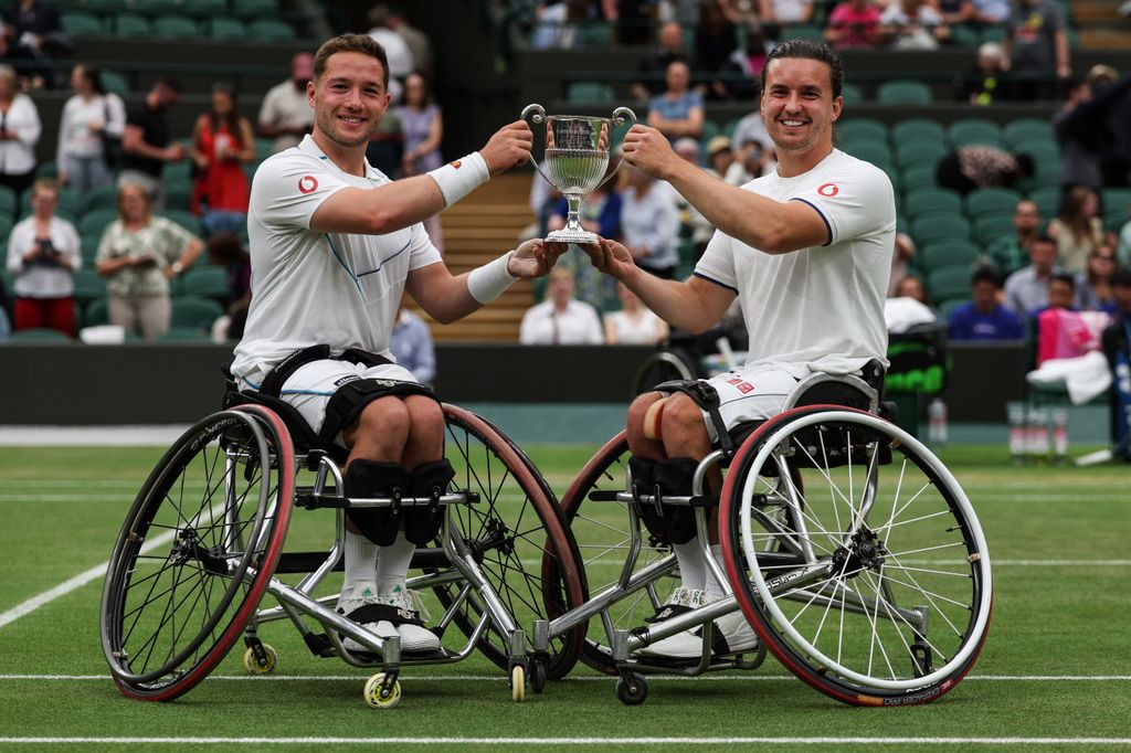 Britain's Alfie Hewett (L) and Gordon Reid pose with their trophy after beating Japan's Takuya Miki and Japan's Tokito Oda during their men's wheelchair doubles final tennis match in 2023 