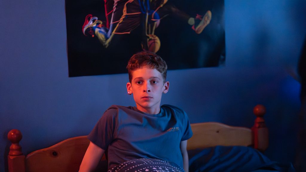 Joe Freeman in character in The Institute in a bed