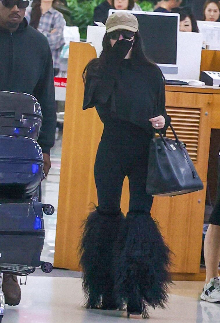 Bianca wore feathered knee high boots and was carrying a large Hermes Birkin bag. 