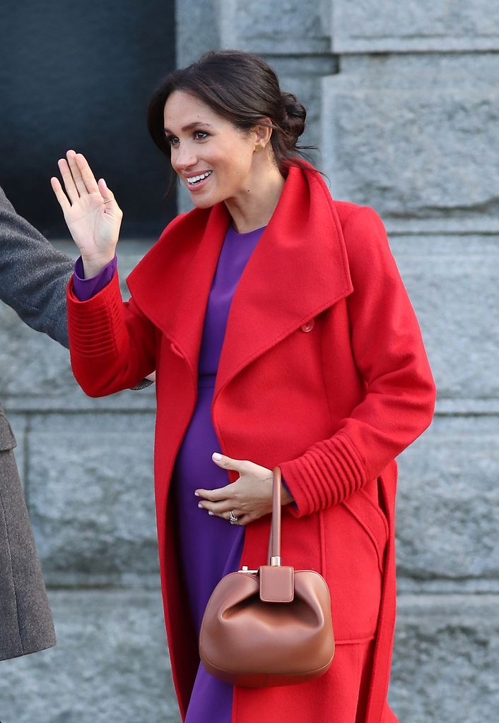 Meghan rocking a bump-skimming purple dress in January 2019