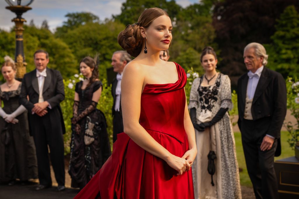 young woman in bold red dress at party