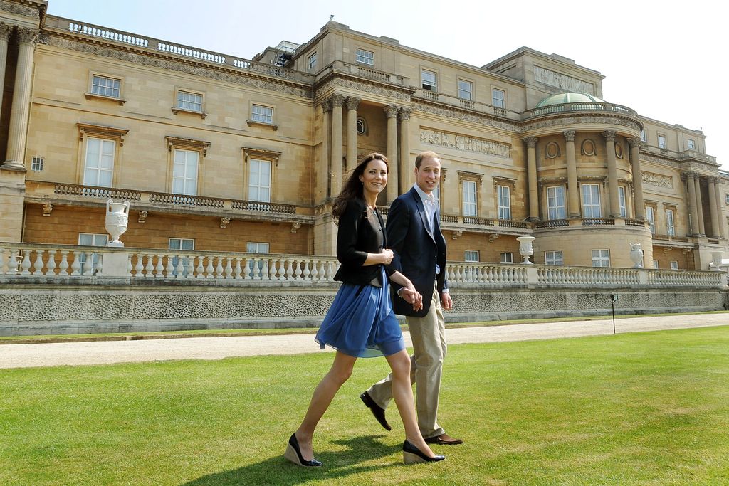 Prince William, and Catherine, walk hand in hand from Buckingham Palace on grass
