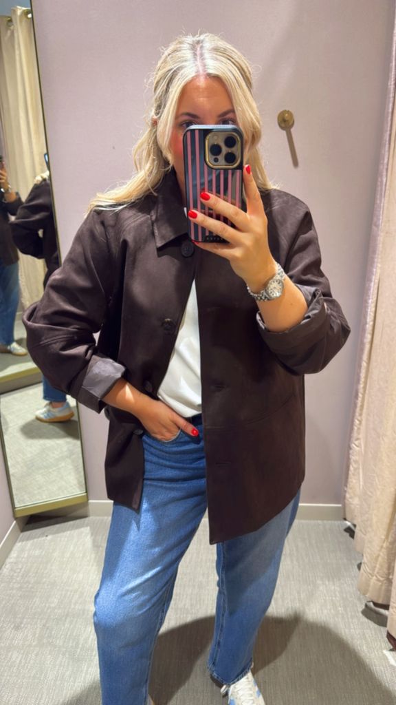 Shopping editor Leanne Bayley wearing a chocolate brown suede shacket from Marks & Spencer. She is styling it with jeans, white tee and adidas sneakers. 