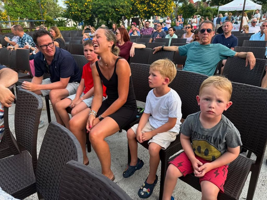 Dylan Dreyer captured mid-laugh while sitting in a crowd with Brian Fichera and their three kids, shared on Instagram