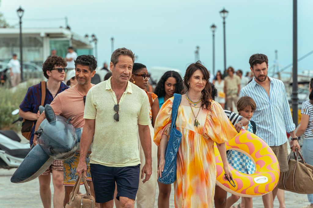 group of people walking down pier