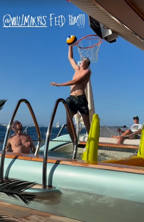Photo of Tom Brady watching his son play basketball on back of their boat near their home in Miami