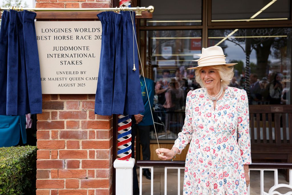 Queen Camilla unveils a plaque during day two of the Sky Bet Ebor Festival 2025 at York Racecourse