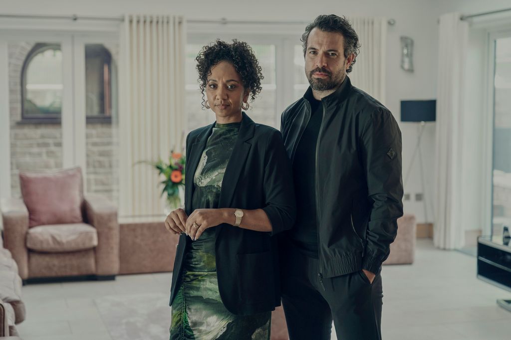 man and woman standing in living room