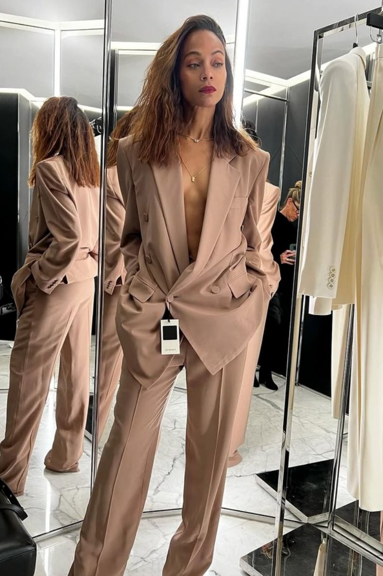 Zoe was seen wearing an oversized tan Saint Laurent blazer completely braless