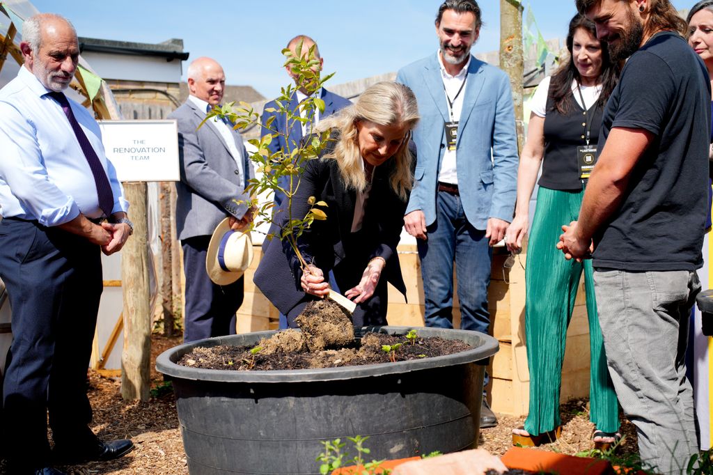 The Duchess of Edinburgh plants a blueberry bush during a visit to The Lighthouse in Aldershot, Hampshire.