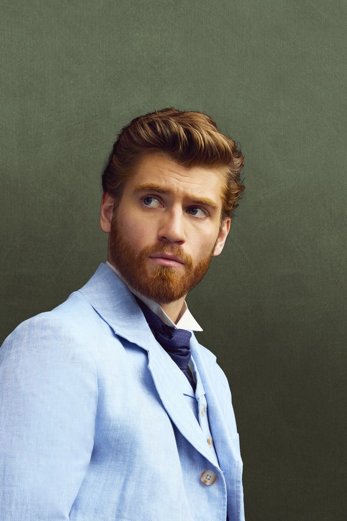 close-up of man in blue suit against green background