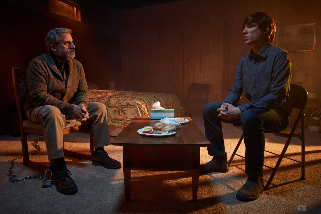 Two men sit in a room