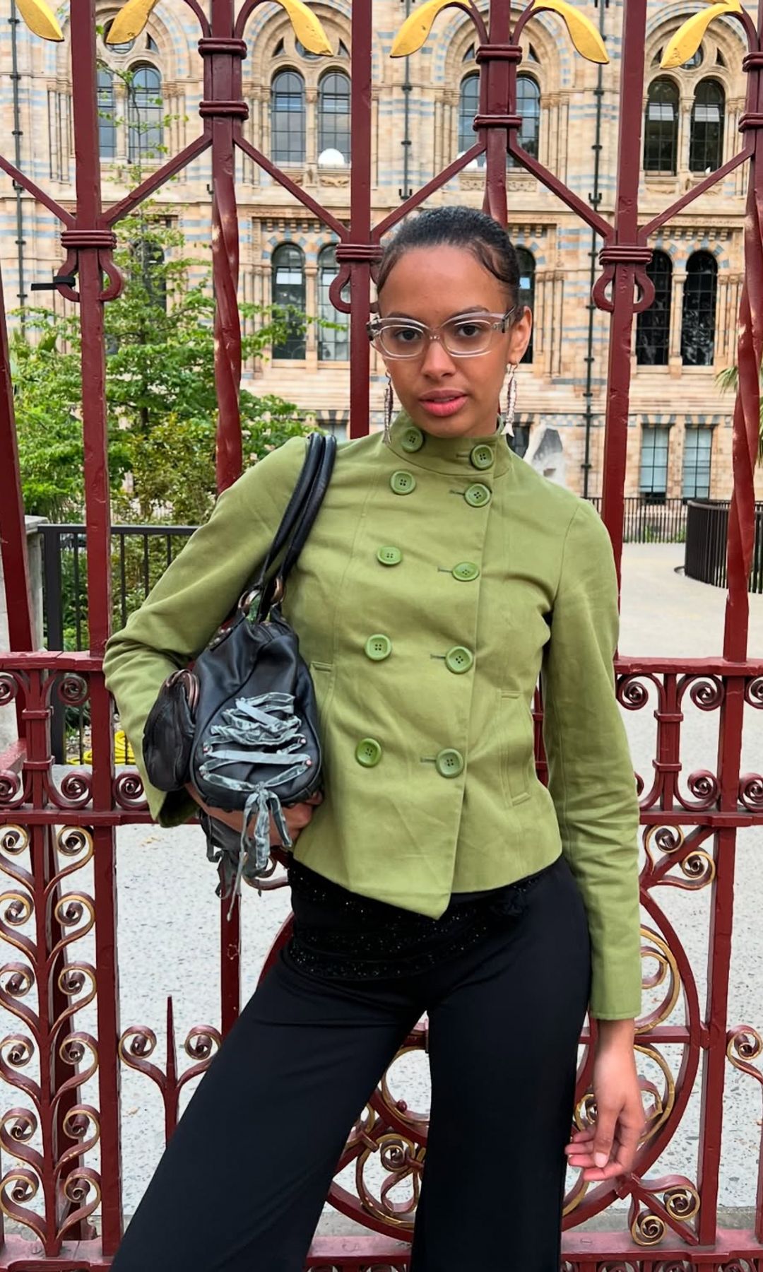 rosie oktocha wears bermuda shorts and green jacket