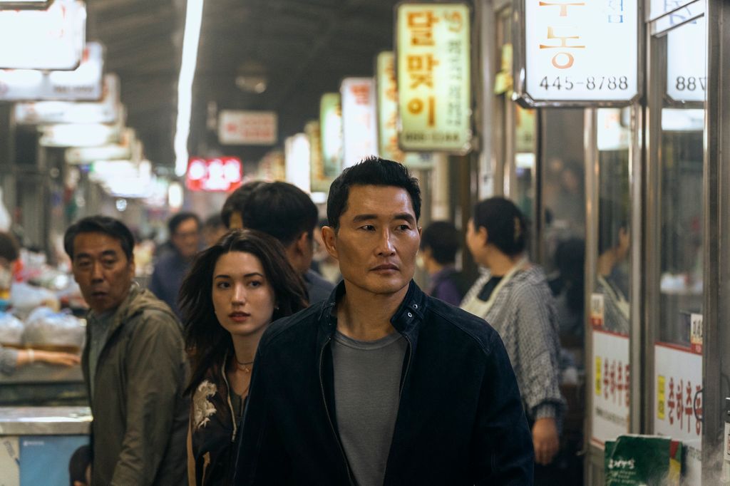 man and woman standing in busy market