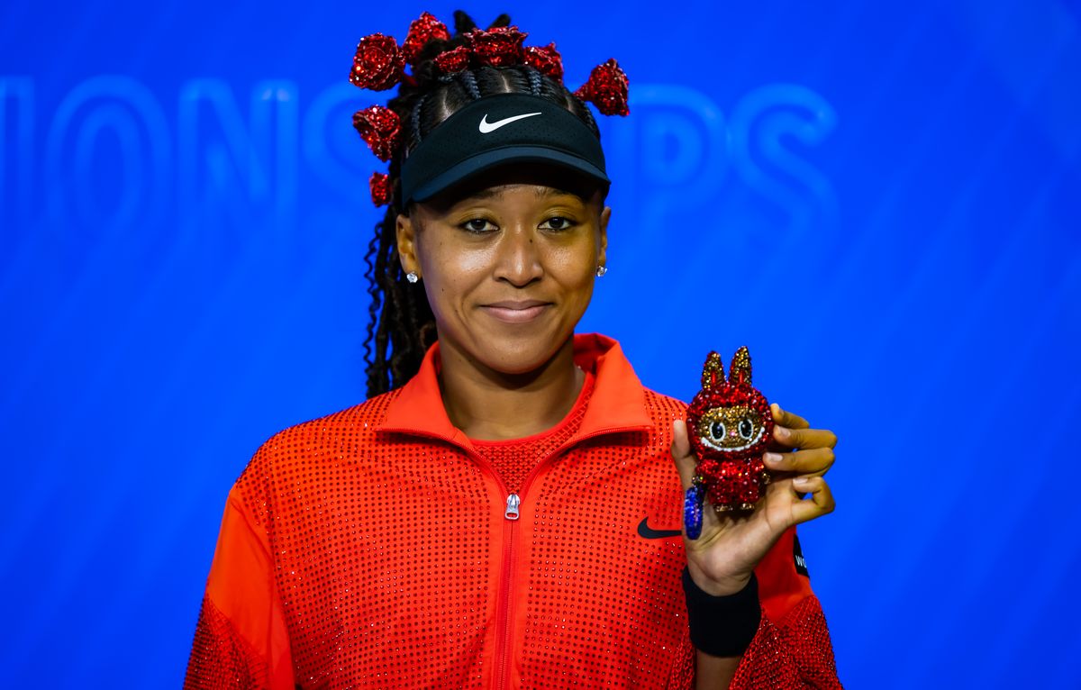 Naomi Osaka poses for a photo with her Labubu after defeating Greet Minnen of Belgium in the first round on Day 3 of the US Open