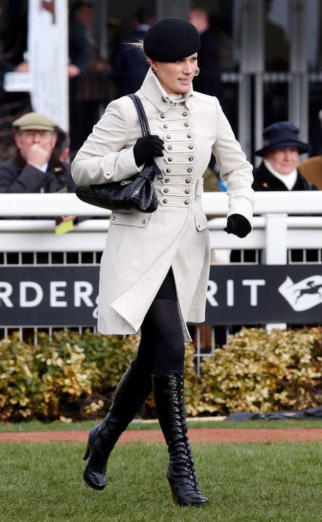 Zara Tindall wearing black patent lace-up boots and a white jacket