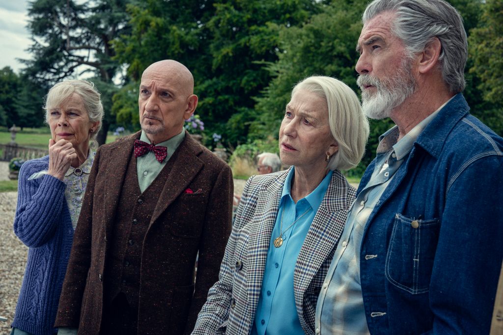 four older people standing in a line