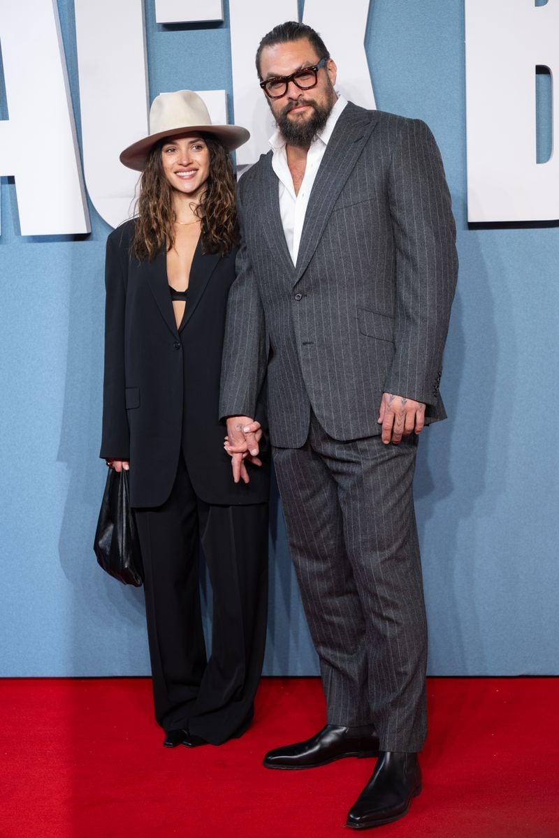 Adria Arjona takes the wheel with Jason Momoa ahead of their getaway— is it an anniversary trip?