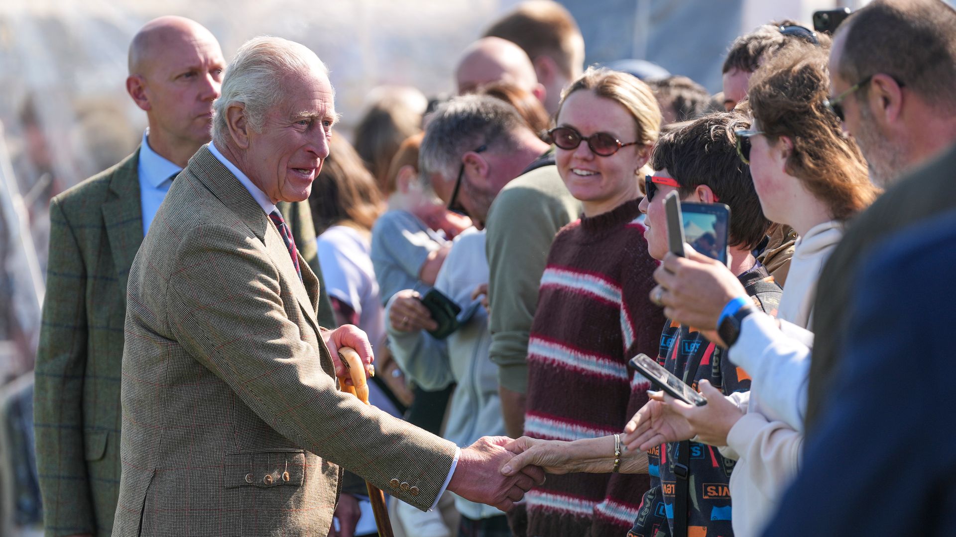 King Charles shaking hands with members of the public