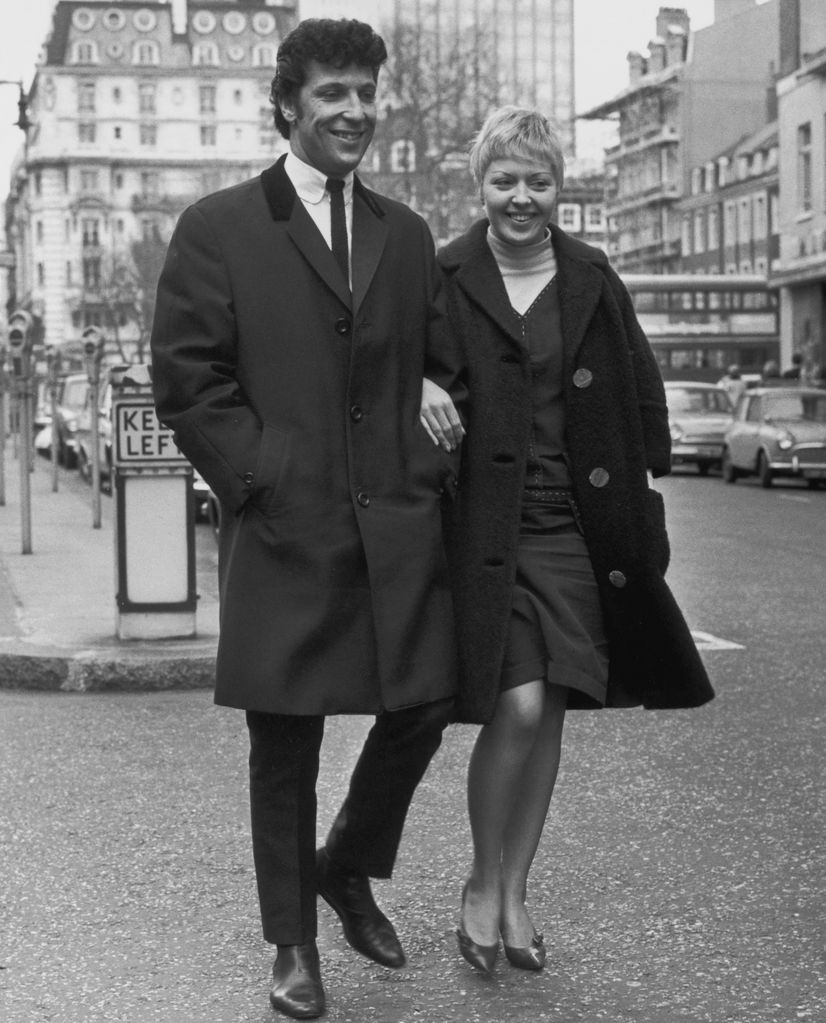 Black-and-white photo of Tom Jones and wife Linda in a street