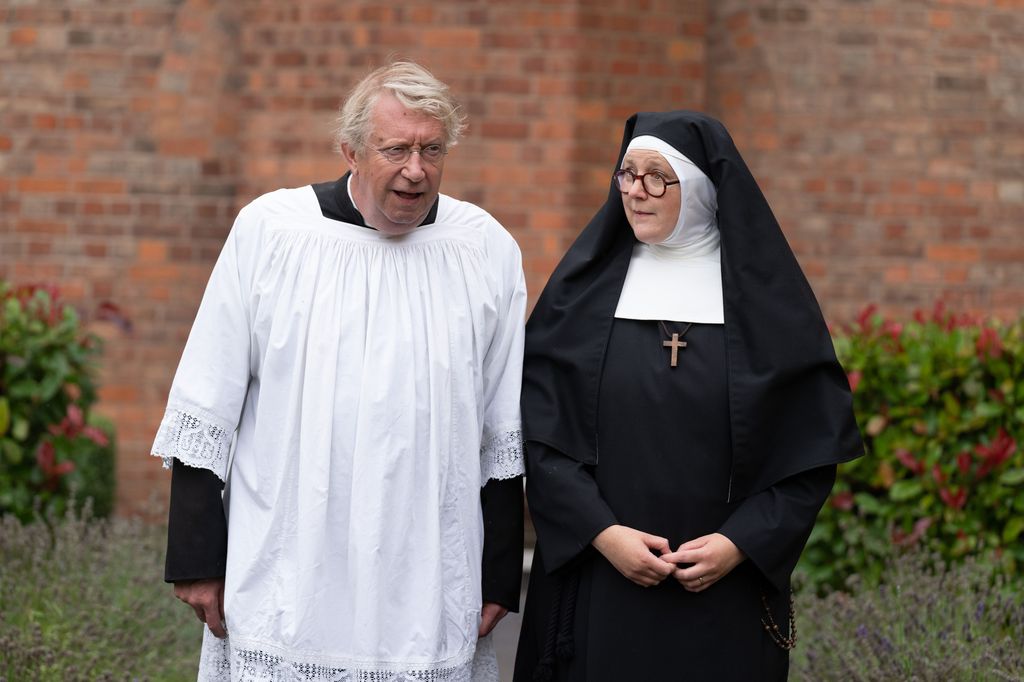 vicar and nun in church yard