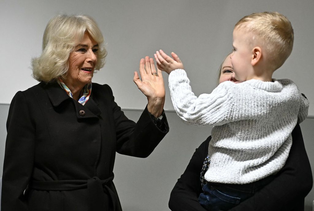 SWINDON, ENGLAND - JANUARY 21: Queen Camilla meets meets blind patient Jackson James and his mother during a visit for the official opening of the new Emergency Department at Great Western Hospital on January 21, 2025 in Swindon, England. (Photo by Ben Stansall - WPA Pool/Getty Images)
