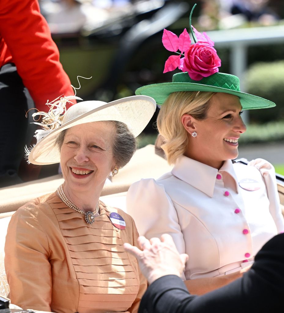 Princess Anne and Zara Tindall at Ascot in 2022 riding in a carriage in smart clothes