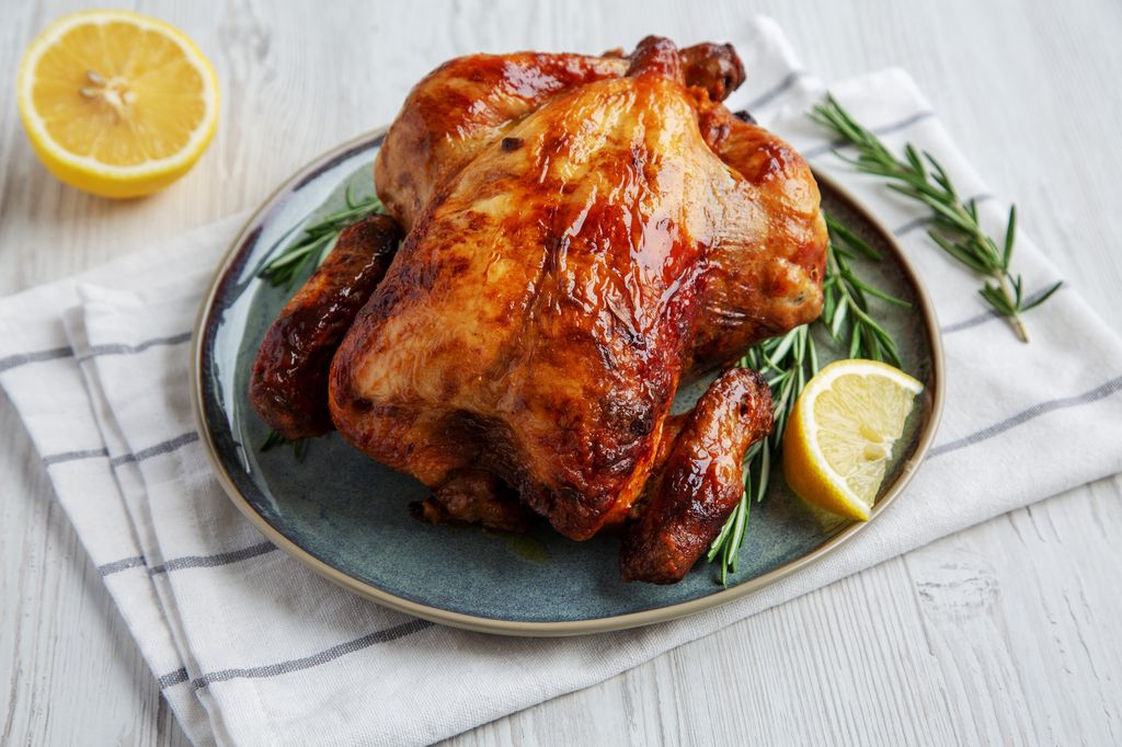 Homemade Lemon and Herb Rotisserie Chicken on a Plate, side view.