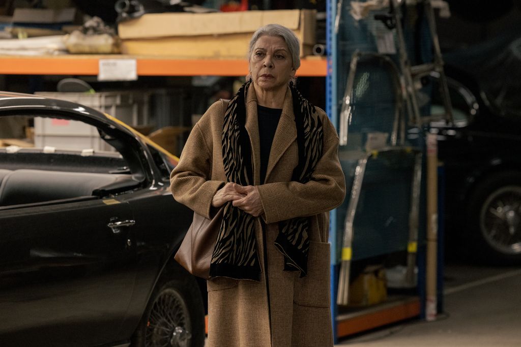 A woman stands in a garage