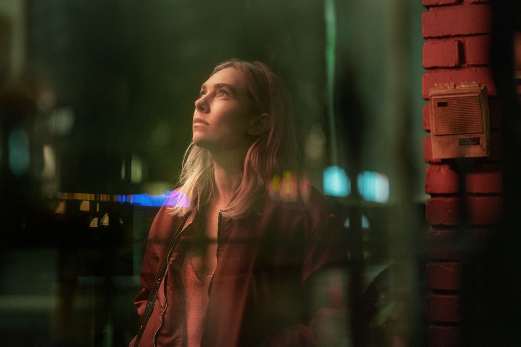 woman standing in street at night