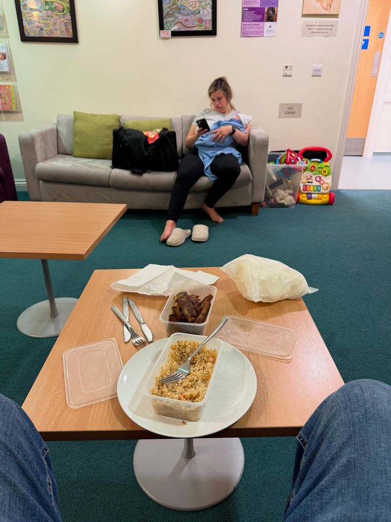 Chinese takeaway on table opposite woman sitting with baby
