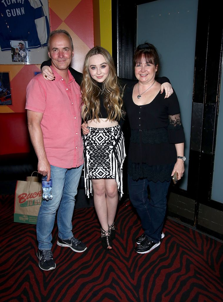 Sabrina Carpenter (C) with her parents pose at Planet Hollywood at Planet Hollywood Times Square on June 7, 2015 in New York City