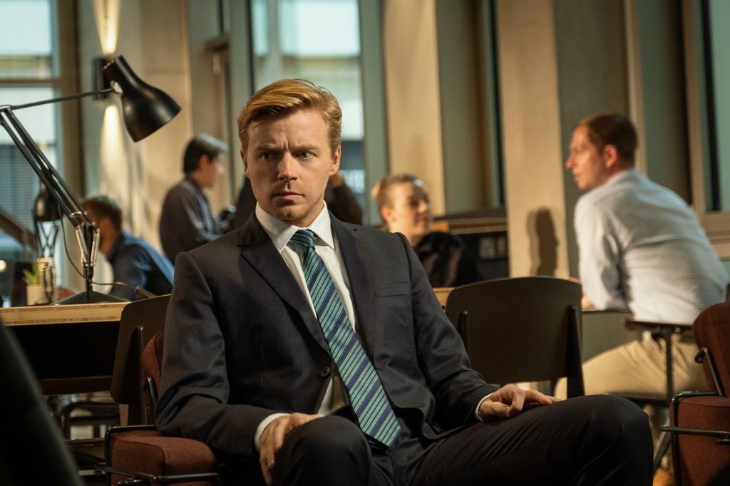 man in suit sitting in office