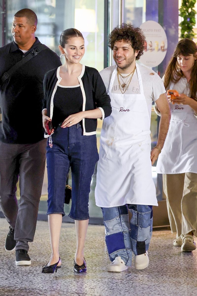 Selena Gomez steps out in LA wearing dark-wash capris and a polished black-and-white cardigan set.