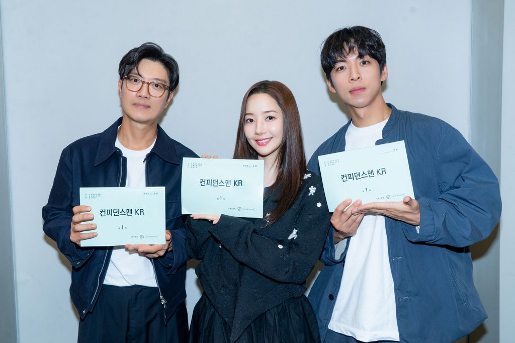 three actors holding up signs