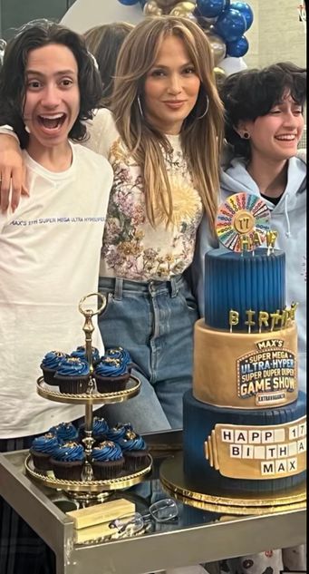 photo of jennifer lopez with twins max and emme standing behind birthday cake