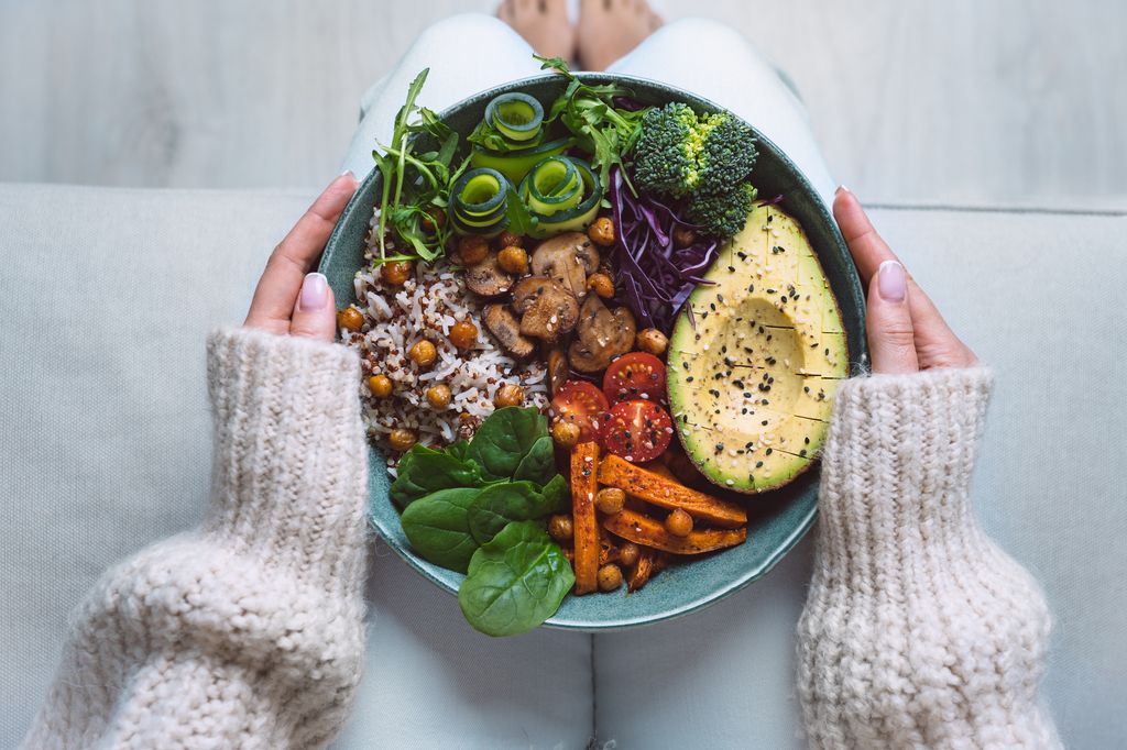 A woman holding a healthy buddha bowl