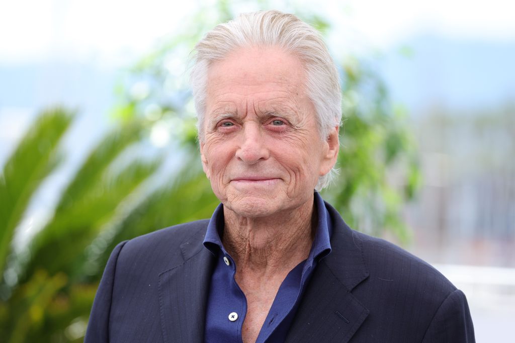 MIchael Douglas smiling tropical backdrop