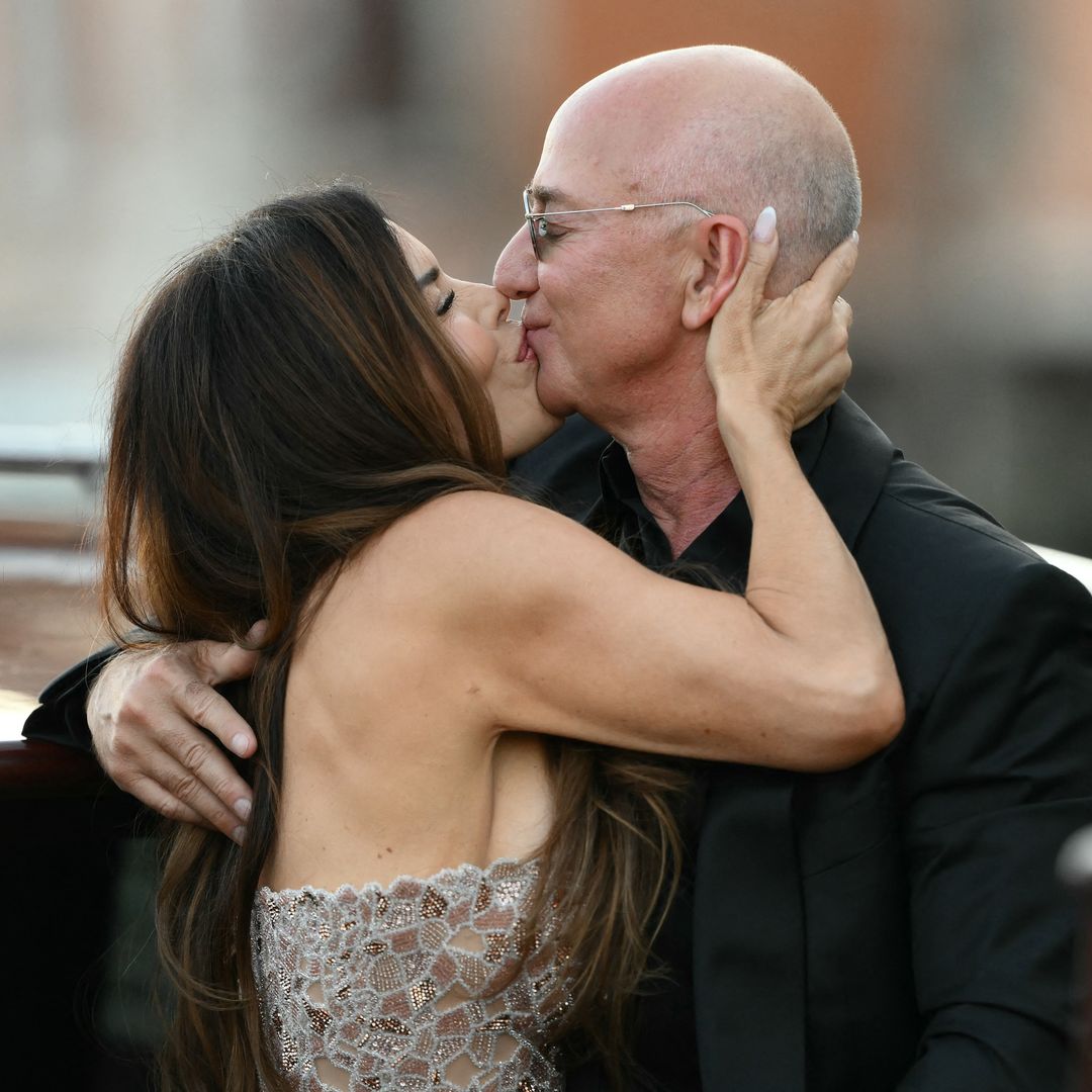 Amazon's founder Jeff Bezos and spouse Lauren Sanchez Bezos kiss as they leave the Aman Hotel on the third day of their wedding festivities, in Venice on June 28, 2025