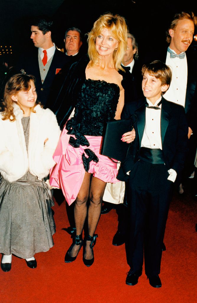 Goldie Hawn smiles as she and her children, Oliver and Kate, attend the gala world premiere screening of her movie Overboard.