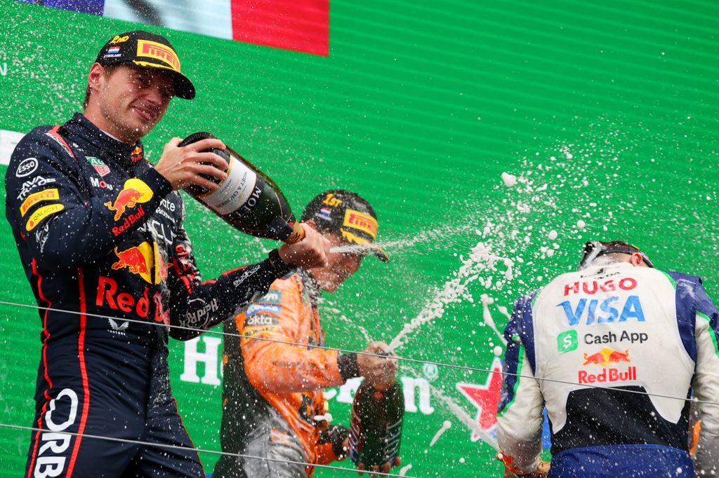 Oscar Piastri of the McLaren F1 Team and Isack Hadjar of the Visa Cash App Racing Bulls F1 Team celebrate on the podium after the race of the Dutch GP, the 15th round of the Formula 1 World Championship