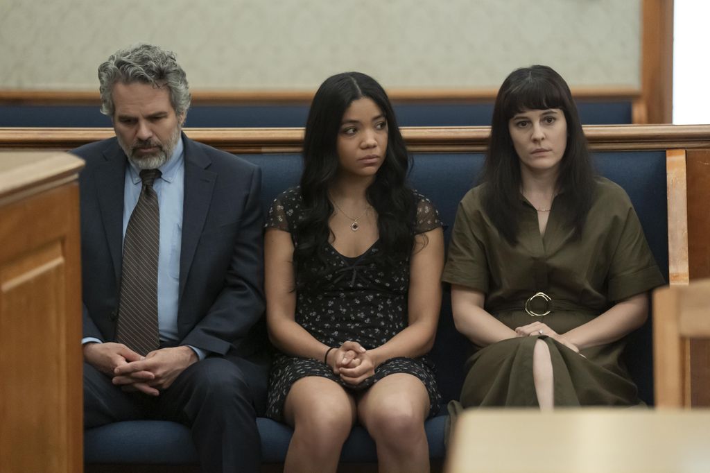 three people sitting in court room