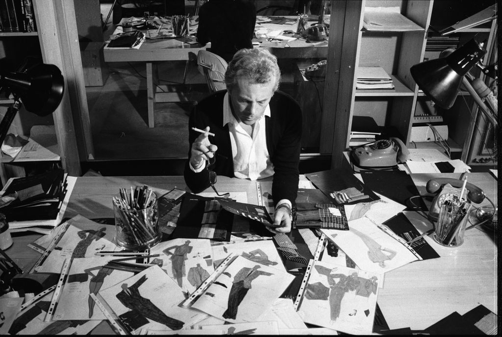 Italian fashion designer Giorgio Armani, born in Piacenza in 1935, examines drawings for new designs, 1979