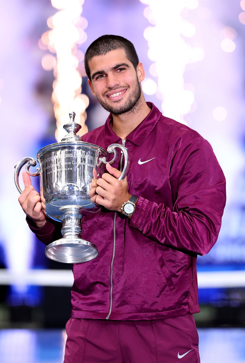 Alcaraz celebrating his win as he holds up his trophy
